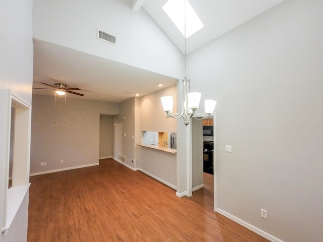 820 Via Madonna, Mesquite, TX 75150 - unfurnished living room with a chandelier, high vaulted ceiling, wood finished floors, a skylight, and a ceiling fan