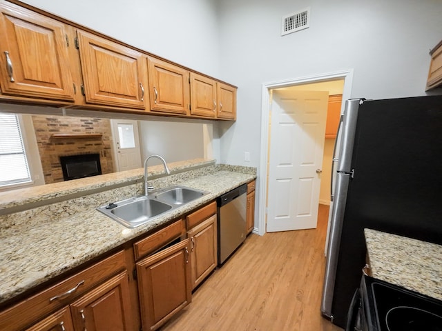 820 Via Madonna, Mesquite, TX 75150 - kitchen with stainless steel appliances, light wood-style flooring, and brown cabinetry