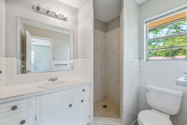 1016 Meadowlark Ln, Stephenville, TX 76401 - bathroom featuring vanity, tile walls, a shower stall, and wainscoting