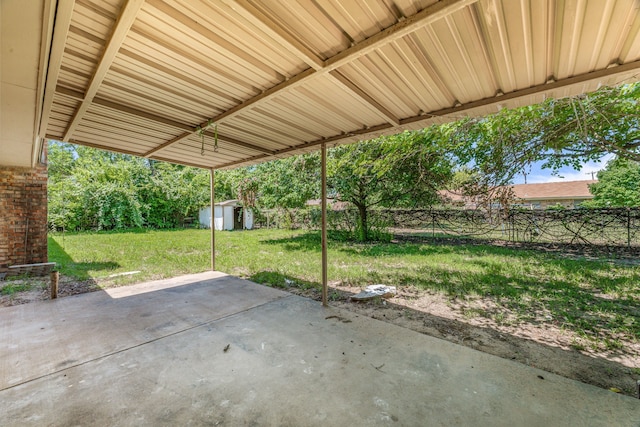 1016 Meadowlark Ln, Stephenville, TX 76401 - fenced backyard featuring a patio area and a storage unit