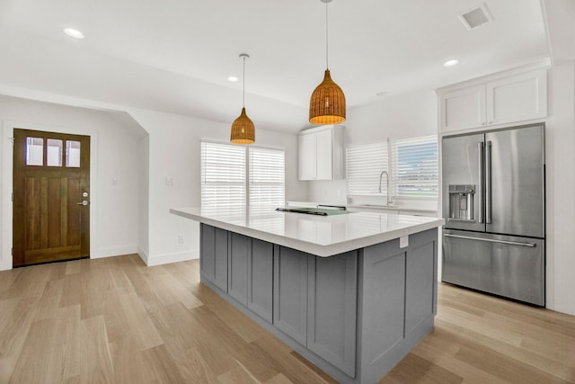 301 E Wall St, Grapevine, TX 76051 - kitchen with high end fridge, light wood finished floors, light countertops, healthy amount of natural light, and recessed lighting