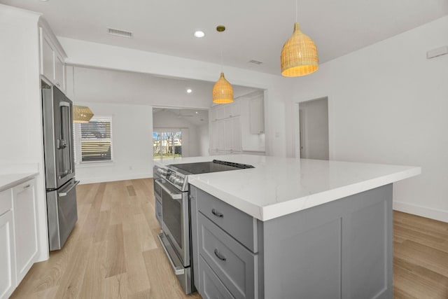 301 E Wall St, Grapevine, TX 76051 - kitchen with stainless steel appliances, gray cabinets, light wood-type flooring, light stone counters, and recessed lighting