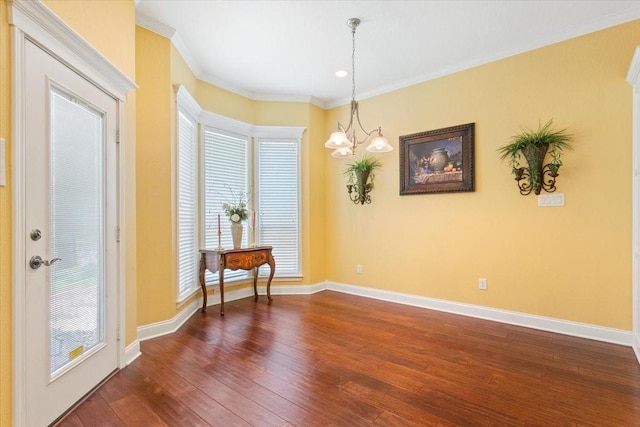 1313 Windstone Dr, Waco, TX 76712 - empty room featuring dark wood-type flooring, a chandelier, and ornamental molding