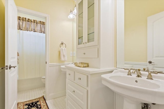 1313 Windstone Dr, Waco, TX 76712 - bathroom featuring a sink and shower / bathtub combination with curtain