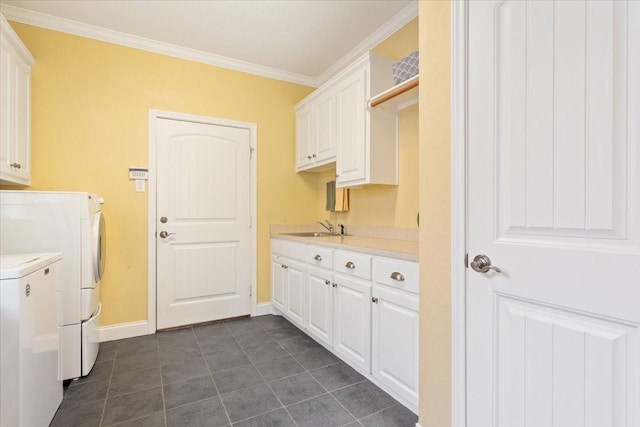 1313 Windstone Dr, Waco, TX 76712 - washroom featuring washer and dryer, cabinet space, crown molding, and dark tile patterned floors