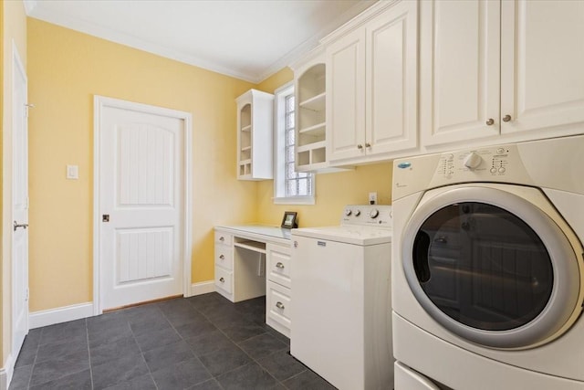 1313 Windstone Dr, Waco, TX 76712 - laundry room with washer and dryer, cabinet space, and dark tile patterned floors