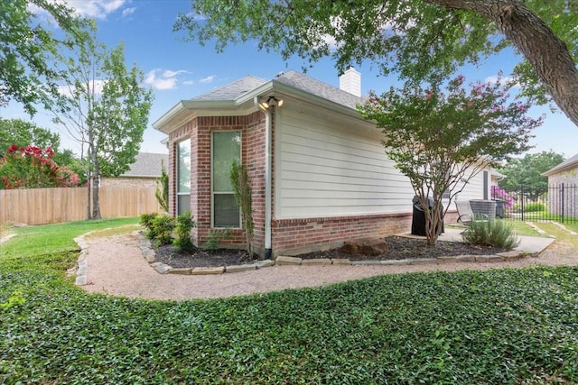 1313 Windstone Dr, Waco, TX 76712 - view of side of home featuring brick siding and a chimney
