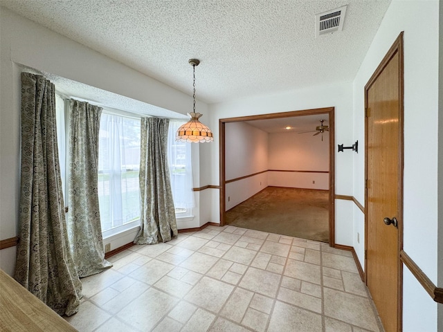 2006 Cornwall Ln, Sachse, TX 75048 - unfurnished dining area featuring healthy amount of natural light, a textured ceiling, and light colored carpet