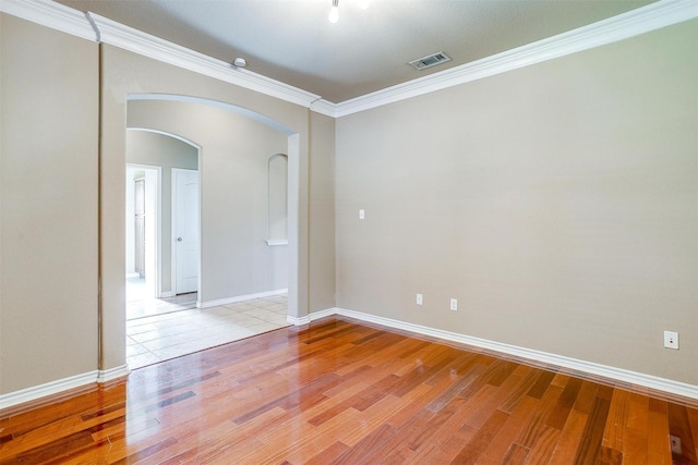 1201 Claire Ct, Burleson, TX 76028 - empty room with arched walkways, light wood-type flooring, and ornamental molding