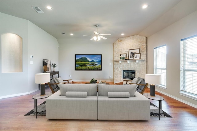 1201 Claire Ct, Burleson, TX 76028 - living room with light wood-style floors, healthy amount of natural light, a stone fireplace, ceiling fan, and recessed lighting
