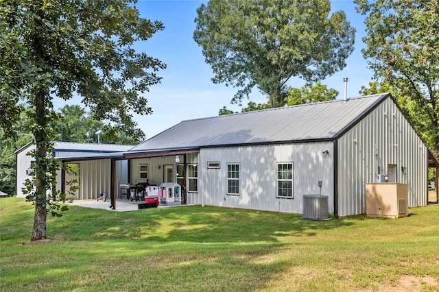 1685 Fleming Rd, Bells, TX 75414 - rear view of property with a lawn, a patio area, board and batten siding, and a metal roof
