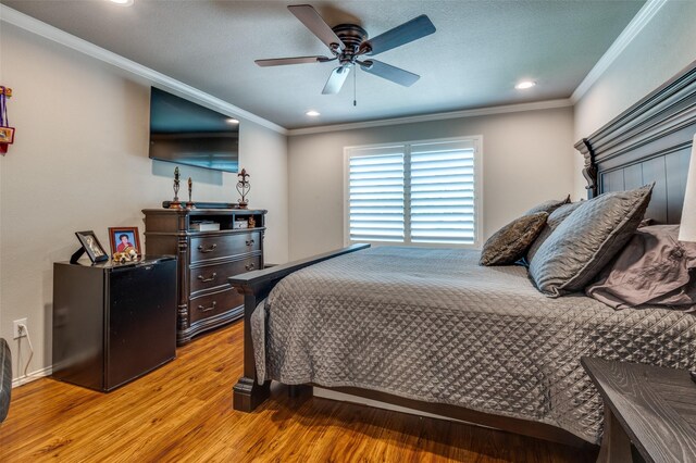 1409 Creekview Dr, Lewisville, TX 75067 - bedroom with crown molding, a barn door, light wood-type flooring, recessed lighting, and a fireplace