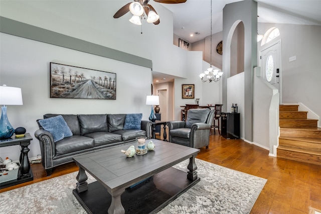 1409 Creekview Dr, Lewisville, TX 75067 - living room with ceiling fan, wood finished floors, stairway, a high ceiling, and a chandelier