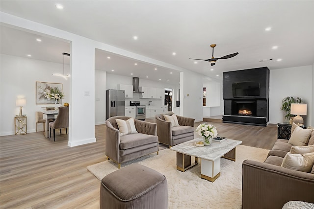 4942 Thunder Rd, Dallas, TX 75244 - living area featuring light wood-type flooring, recessed lighting, ceiling fan, and a large fireplace