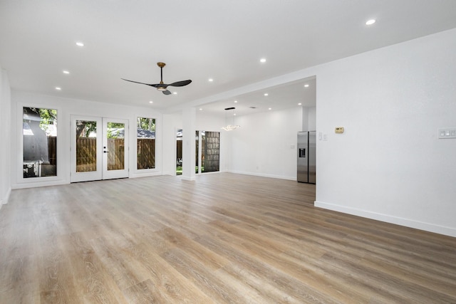 4942 Thunder Rd, Dallas, TX 75244 - unfurnished living room with recessed lighting, a ceiling fan, light wood-style flooring, a chandelier, and french doors