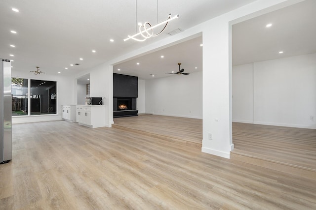 4942 Thunder Rd, Dallas, TX 75244 - unfurnished living room featuring ceiling fan, light wood-type flooring, a fireplace, and recessed lighting