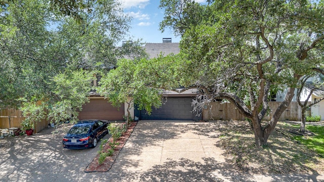 4942 Thunder Rd, Dallas, TX 75244 - view of property hidden behind natural elements featuring concrete driveway and a garage