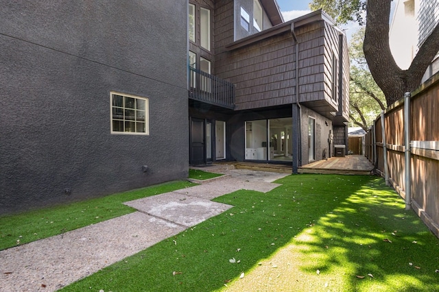 4942 Thunder Rd, Dallas, TX 75244 - back of house with a fenced backyard, stucco siding, a deck, and mansard roof