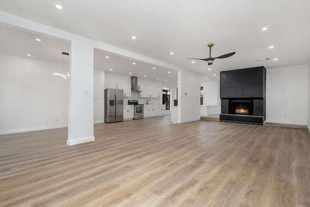 4942 Thunder Rd, Dallas, TX 75244 - unfurnished living room featuring ceiling fan, recessed lighting, light wood finished floors, and a fireplace