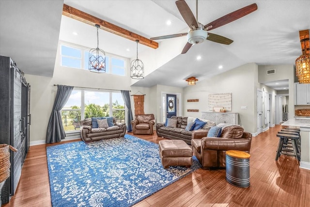 612 W Park Ave, Weatherford, TX 76086 - living area with ceiling fan, high vaulted ceiling, wood finished floors, recessed lighting, and a chandelier