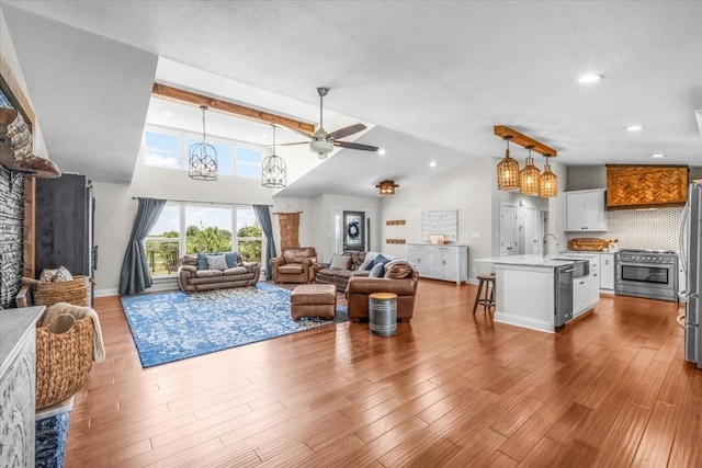 612 W Park Ave, Weatherford, TX 76086 - living room featuring ceiling fan, a chandelier, wood finished floors, recessed lighting, and high vaulted ceiling