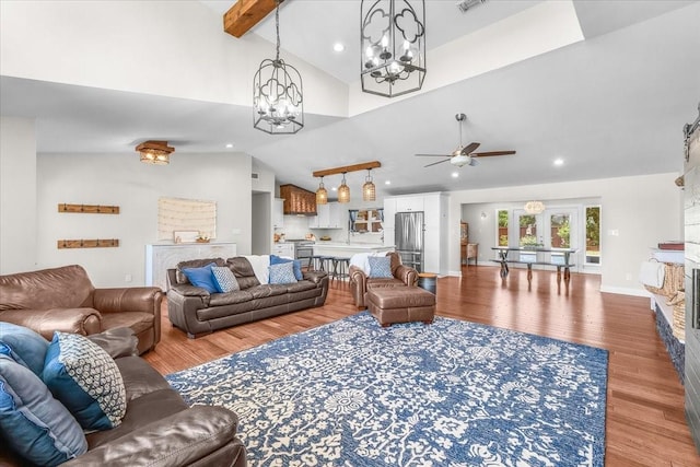 612 W Park Ave, Weatherford, TX 76086 - living area featuring light wood finished floors, a ceiling fan, a large fireplace, recessed lighting, and a chandelier