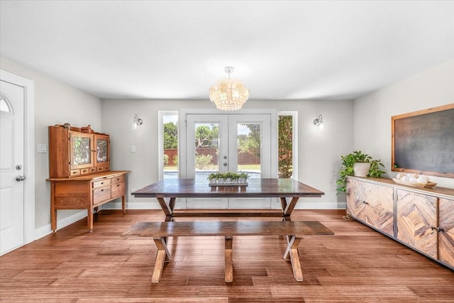 612 W Park Ave, Weatherford, TX 76086 - dining area featuring a chandelier, wood finished floors, and french doors