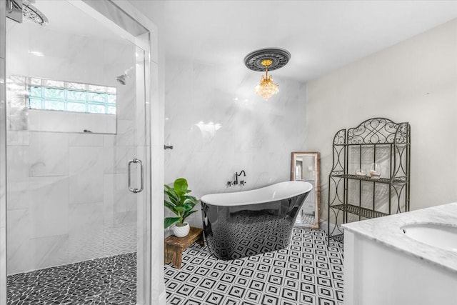 612 W Park Ave, Weatherford, TX 76086 - full bathroom featuring a stall shower, a soaking tub, vanity, and tile patterned floors