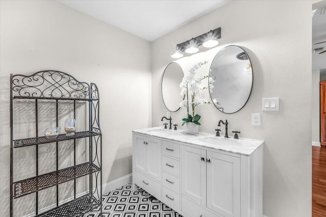 612 W Park Ave, Weatherford, TX 76086 - bathroom with double vanity and baseboards