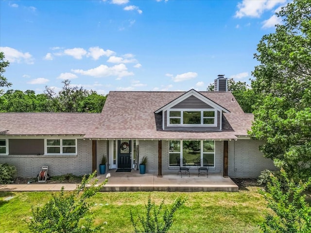 612 W Park Ave, Weatherford, TX 76086 - view of front of property with brick siding, a front yard, a chimney, and a shingled roof