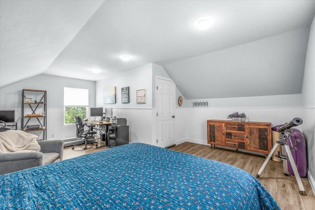 612 W Park Ave, Weatherford, TX 76086 - bedroom featuring lofted ceiling, wood finished floors, and a desk