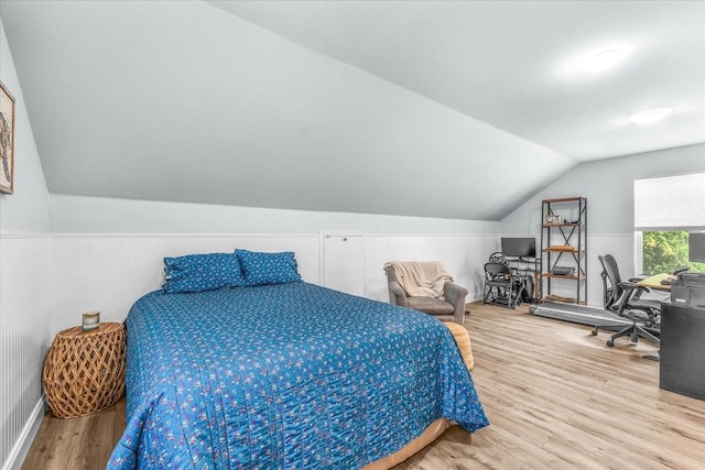 612 W Park Ave, Weatherford, TX 76086 - bedroom featuring wood finished floors, lofted ceiling, a desk, and a wainscoted wall