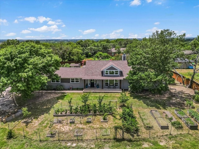 612 W Park Ave, Weatherford, TX 76086 - rear view of house featuring a garden and a chimney