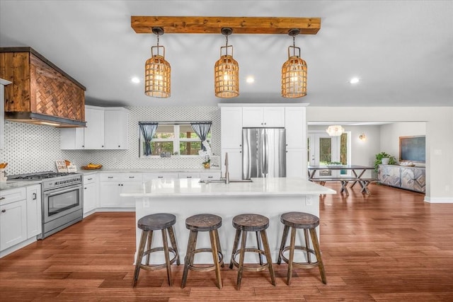 612 W Park Ave, Weatherford, TX 76086 - kitchen featuring appliances with stainless steel finishes, decorative backsplash, a kitchen breakfast bar, light countertops, and beamed ceiling