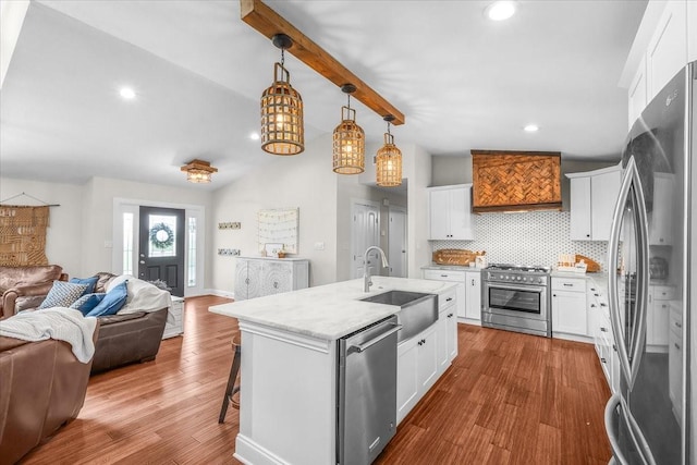 612 W Park Ave, Weatherford, TX 76086 - kitchen with appliances with stainless steel finishes, open floor plan, custom exhaust hood, a breakfast bar area, and dark wood-style floors