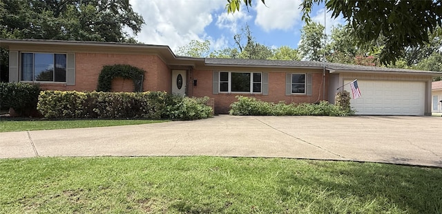 2015 E 5th St, Tyler, TX 75701 - single story home with an attached garage, concrete driveway, brick siding, and a front yard