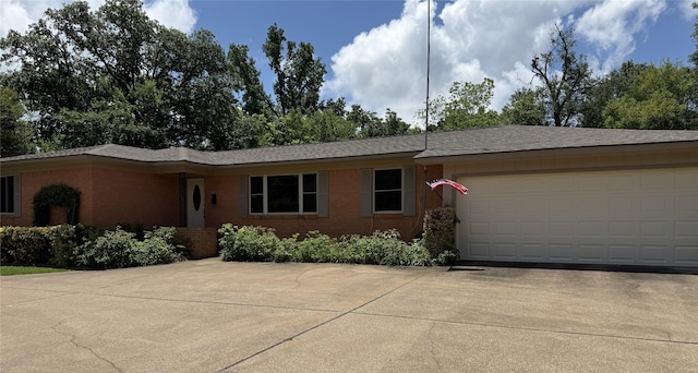 2015 E 5th St, Tyler, TX 75701 - ranch-style home with brick siding, concrete driveway, and an attached garage