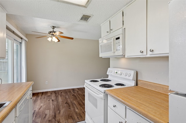 6569 Westridge Dr, Watauga, TX 76148 - kitchen with white appliances, a ceiling fan, dark wood-style flooring, white cabinets, and a textured ceiling