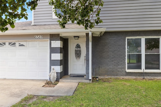 6569 Westridge Dr, Watauga, TX 76148 - property entrance featuring brick siding, concrete driveway, and a yard