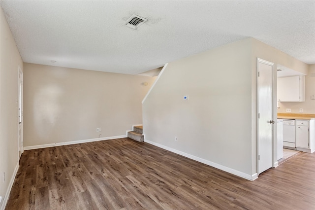6569 Westridge Dr, Watauga, TX 76148 - unfurnished living room featuring light wood-type flooring, stairs, and a textured ceiling