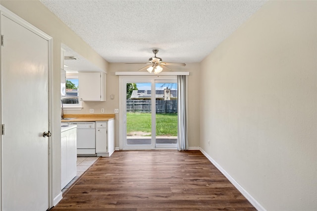 6569 Westridge Dr, Watauga, TX 76148 - kitchen featuring white dishwasher, ceiling fan, white cabinets, wood finished floors, and a textured ceiling