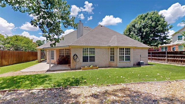 6218 Aspen Estates Dr, Sachse, TX 75048 - back of property with brick siding, a patio, a fenced backyard, and a chimney