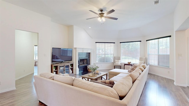 6218 Aspen Estates Dr, Sachse, TX 75048 - living area featuring a tile fireplace, a ceiling fan, wood finished floors, and lofted ceiling