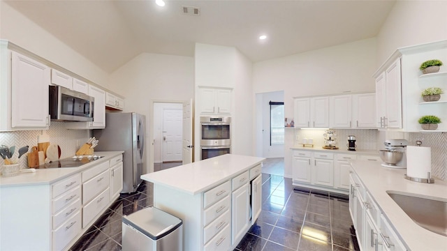 6218 Aspen Estates Dr, Sachse, TX 75048 - kitchen featuring appliances with stainless steel finishes, open shelves, white cabinetry, a kitchen island, and recessed lighting