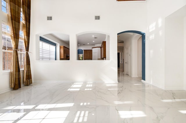 2742 Hidden Knoll Trl, Frisco, TX 75034 - unfurnished living room featuring a high ceiling and light marble finish floors