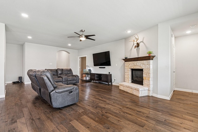 1813 Drover Creek Rd, Aubrey, TX 76227 - living room with recessed lighting, dark wood-type flooring, arched walkways, a ceiling fan, and a fireplace