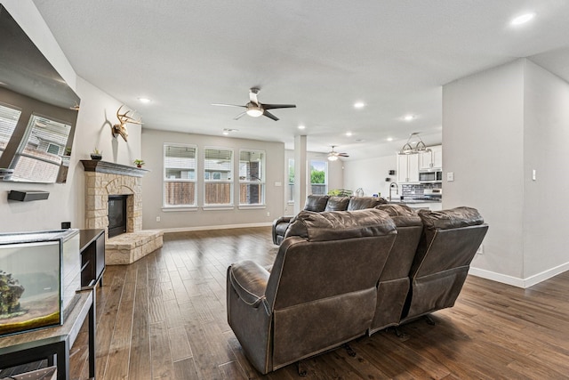 1813 Drover Creek Rd, Aubrey, TX 76227 - living area with a stone fireplace, ceiling fan, dark wood-style floors, and recessed lighting