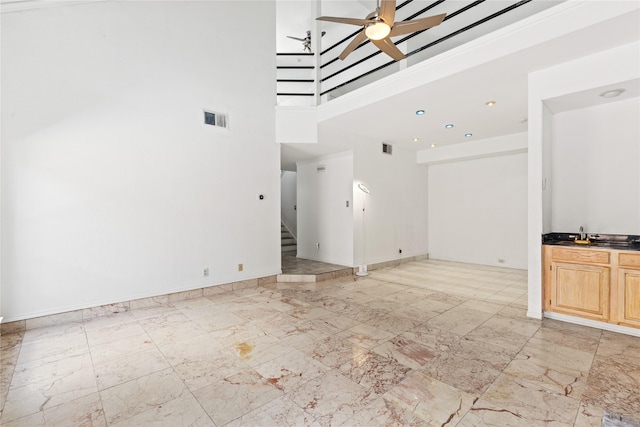 2707 Garden Springs Dr, Richardson, TX 75082 - unfurnished living room with stairway, a ceiling fan, and a towering ceiling