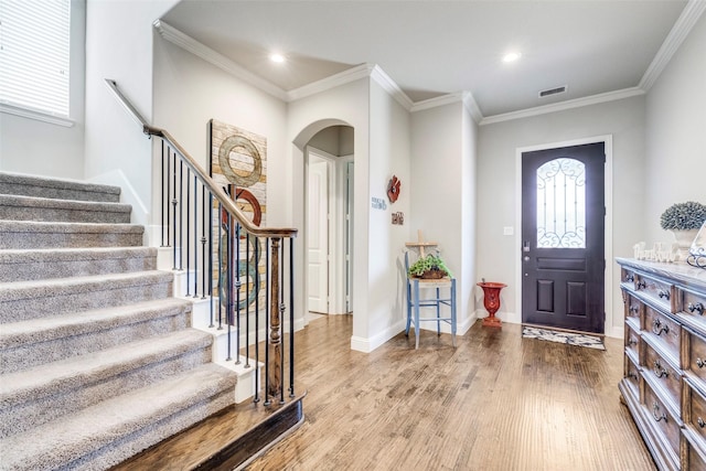 3300 Western Bluff Ct, Mansfield, TX 76063 - foyer entrance featuring arched walkways, crown molding, wood finished floors, stairway, and healthy amount of natural light