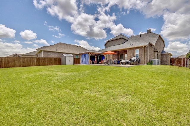 3300 Western Bluff Ct, Mansfield, TX 76063 - back of house with a storage shed, a patio, a fenced backyard, a chimney, and a gazebo